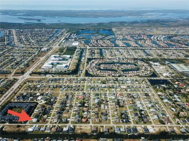 Birds eye view of property with a water view