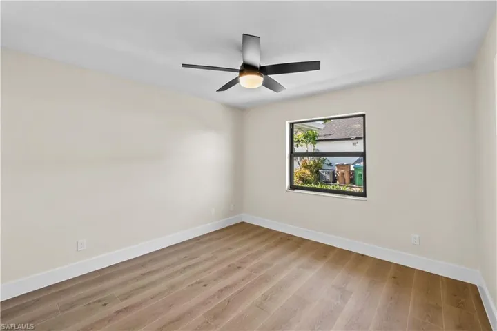 Empty room featuring ceiling fan and light wood-type flooring