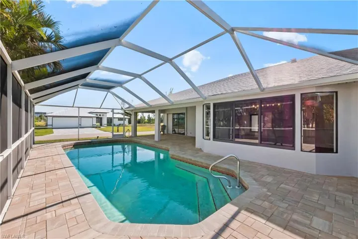 View of pool with a lanai and a patio area