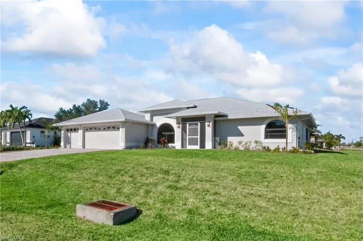 Ranch-style home featuring a front yard and a garage