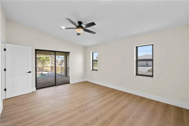 Unfurnished bedroom with ceiling fan, light hardwood / wood-style floors, and multiple windows