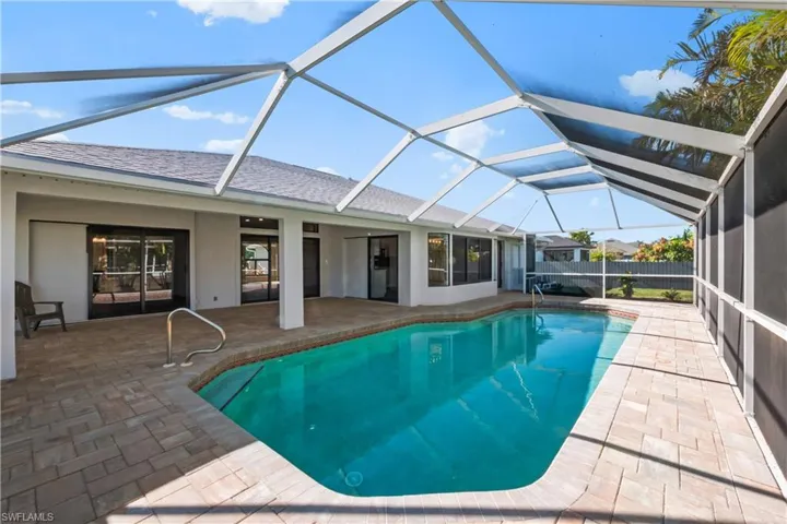 View of swimming pool featuring a lanai, a patio area, and ceiling fan