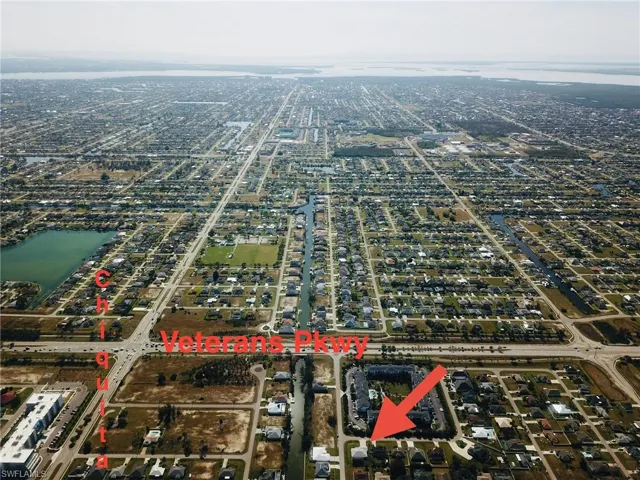 Birds eye view of property with a water view