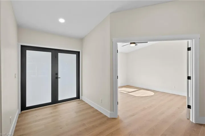 Foyer with french doors and light hardwood / wood-style flooring