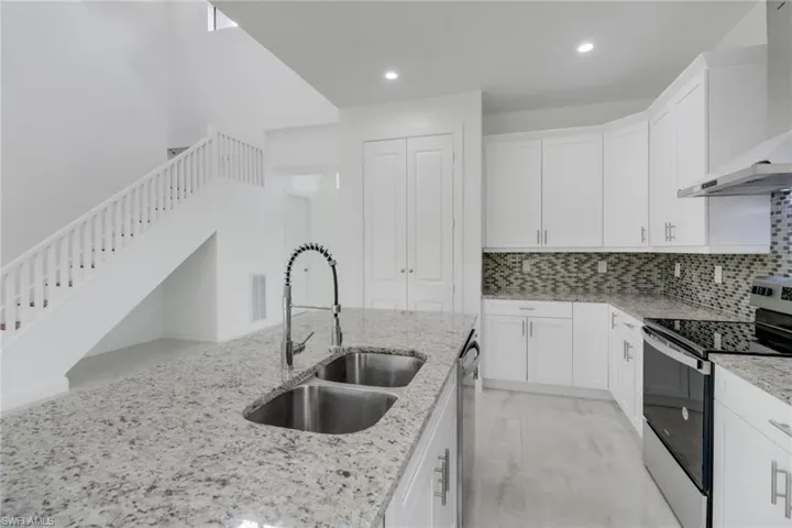 Kitchen with light stone countertops.