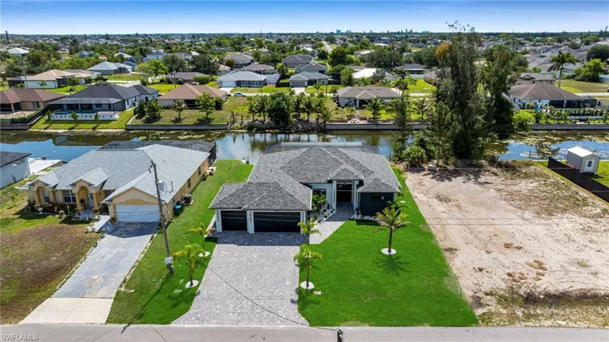 Aerial perspective of suburban area with a large body of water