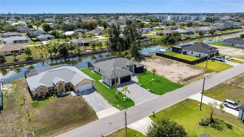 Aerial view of residential area featuring a large body of water