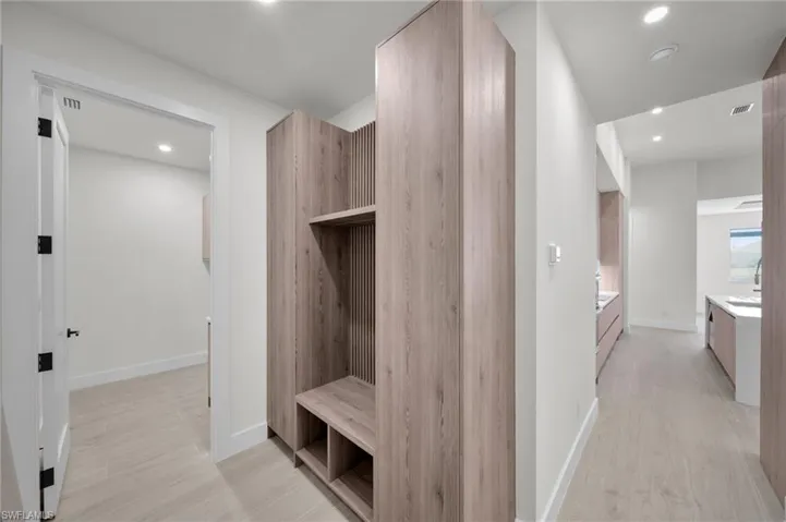 Mudroom with light wood-type flooring, recessed lighting, and baseboards