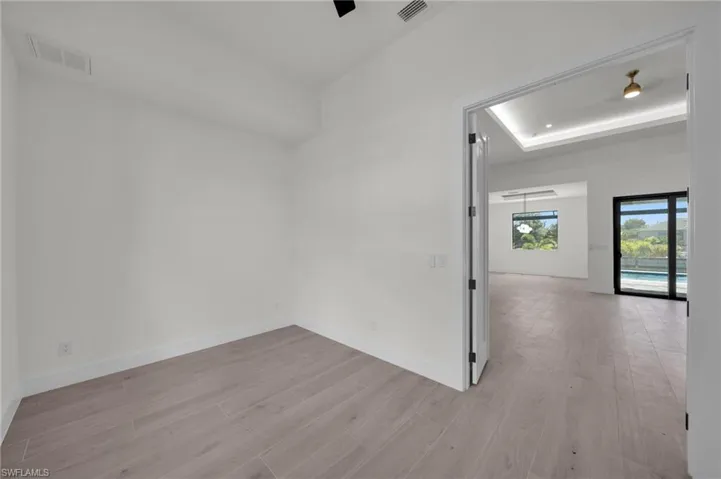 Spare room featuring light wood-style floors and baseboards