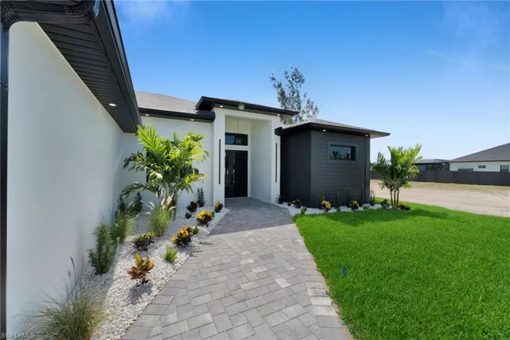 Contemporary house with stucco siding and a front yard
