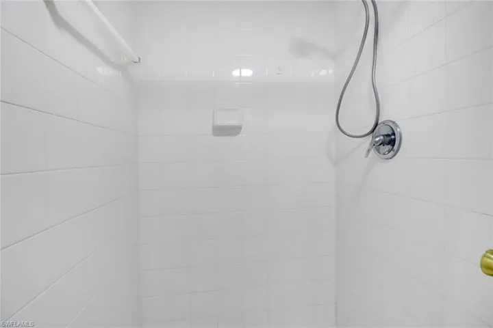 Room details featuring tiled shower