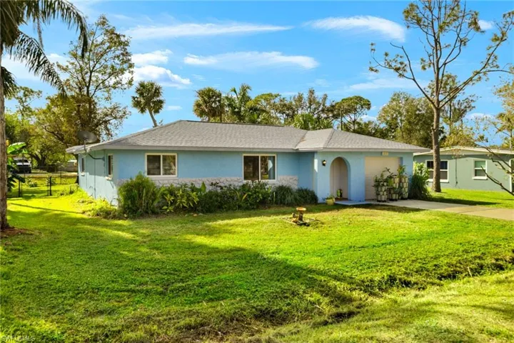 Single story home with a front yard