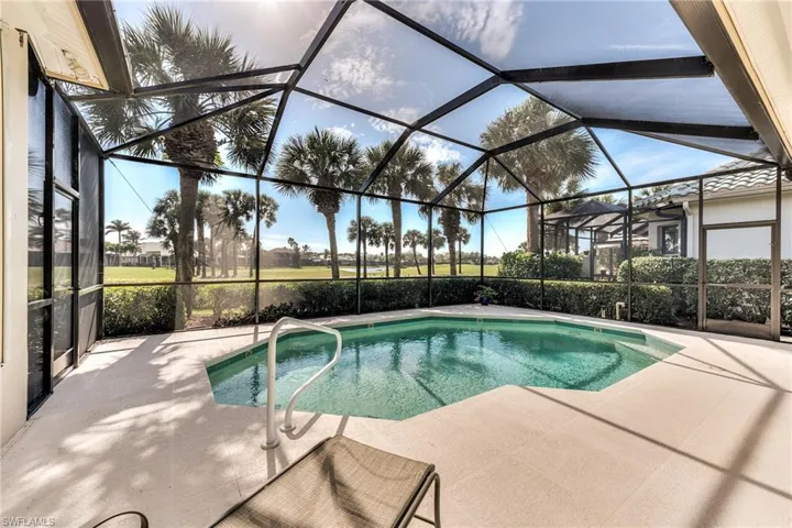 View of pool with screen enclosure and a patio featuring preferred southern exposure