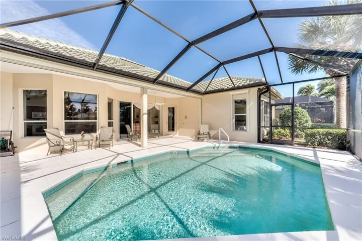 View of swimming pool, patio, and screen enclosure