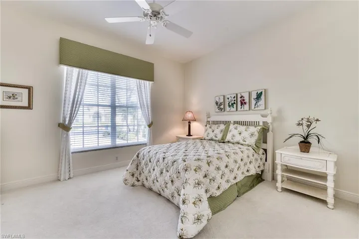Bedroom featuring ceiling fan and carpet