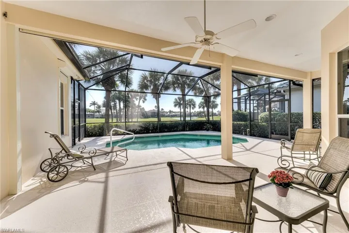 View of swimming pool featuring a lanai, ceiling fan, and a patio