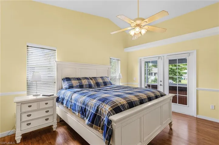 Bedroom with french doors, ceiling fan, access to exterior, and dark wood-type flooring