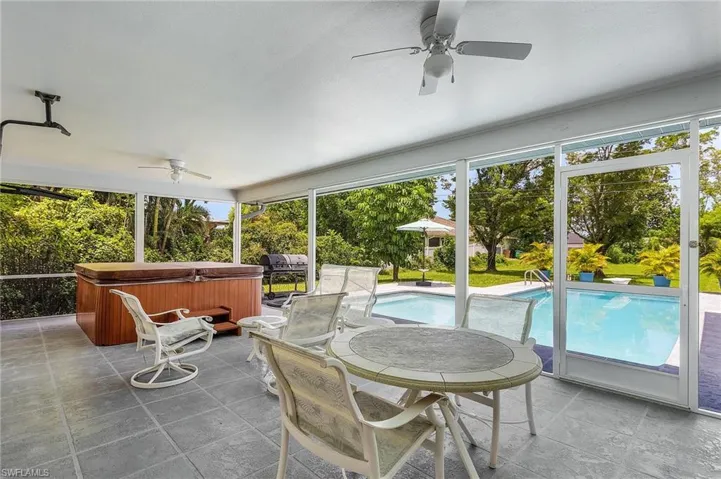 Sunroom / solarium featuring ceiling fan