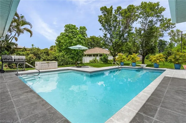 View of swimming pool featuring a patio, a jacuzzi, and a diving board