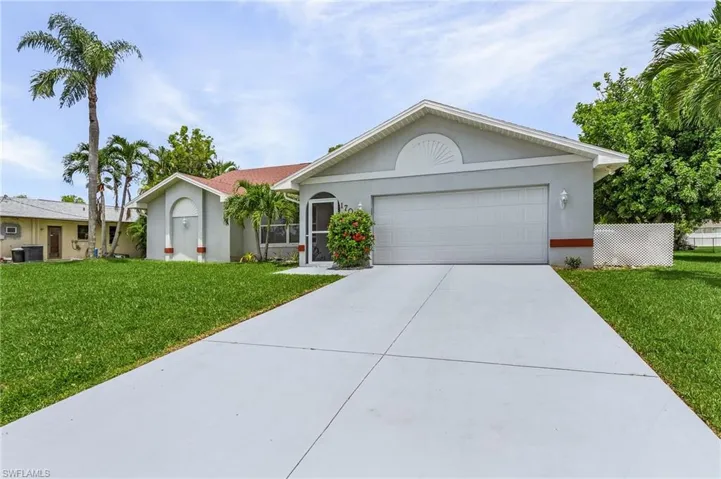 Ranch-style house with a garage, a front yard, and central AC unit