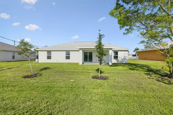Rear view of house with a yard