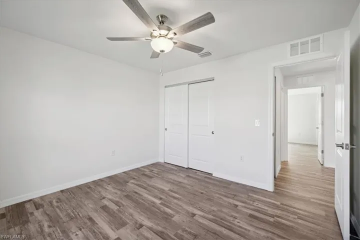 Unfurnished bedroom with a closet, ceiling fan, and hardwood / wood-style floors