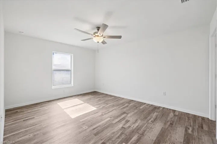 Empty room featuring light hardwood / wood-style flooring and ceiling fan