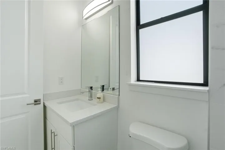 Half bath featuring vanity and toilet