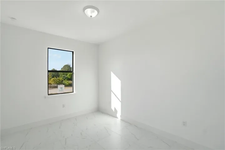Empty room with baseboards and light marble finish flooring