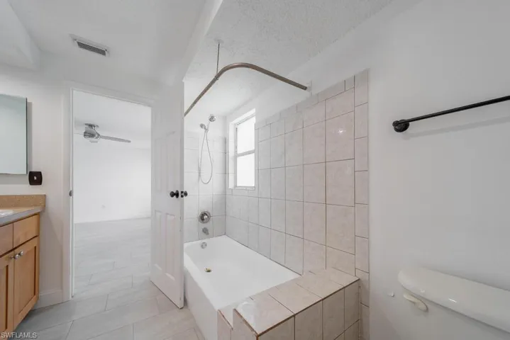 Primary Bathroom, door to garage, needs some updating