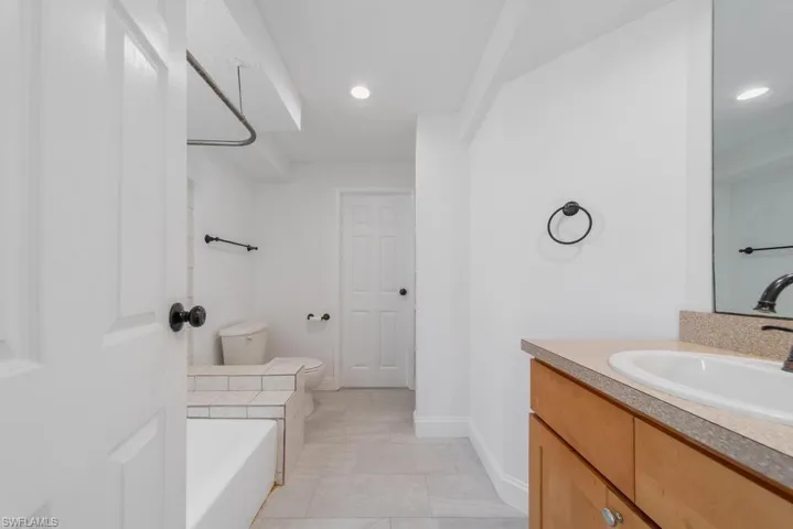 Primary Bathroom, door to garage, needs some updating