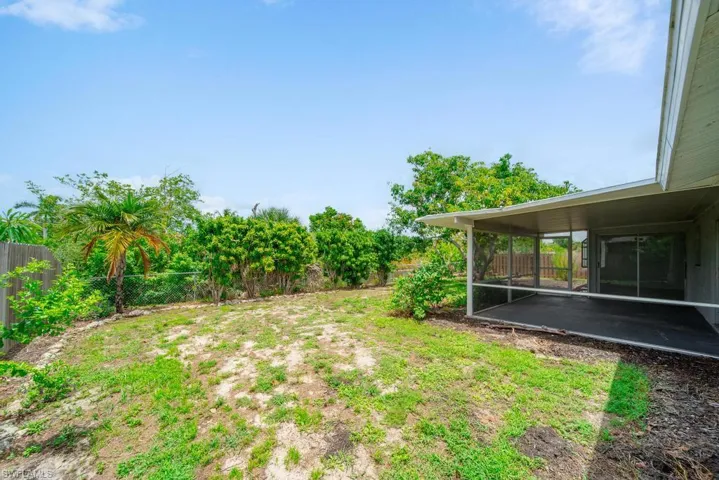 Left Side Back Yard, large screened in lanai.
