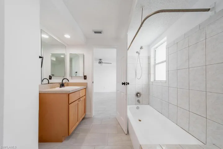 Primary Bathroom, door to garage, needs some updating
