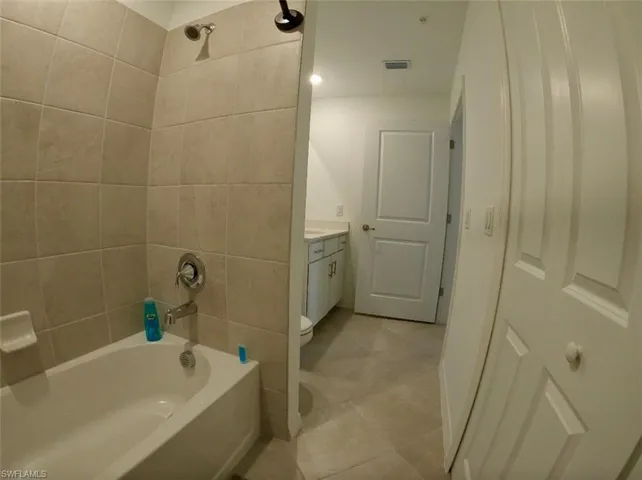 Full bathroom with  shower combination, vanity, and light tile patterned flooring