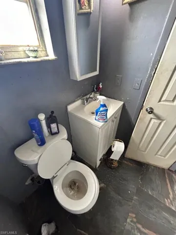 Bathroom with tile flooring, vanity, and toilet