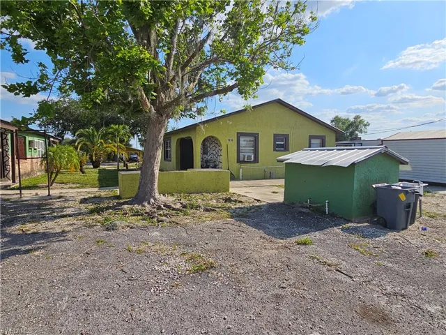 View of side of home featuring a yard