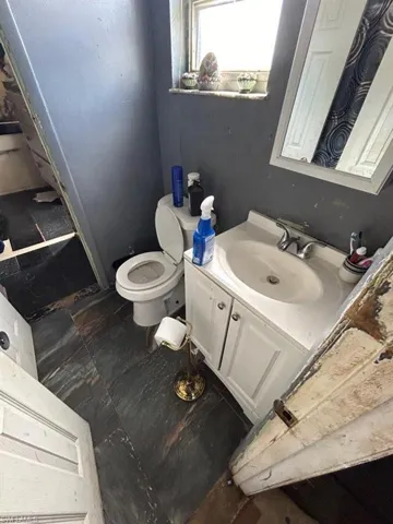 Bathroom featuring tile flooring, toilet, and vanity