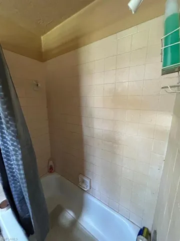 Bathroom with shower / bath combo with shower curtain