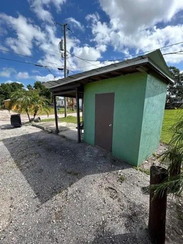 View of property exterior featuring a shed