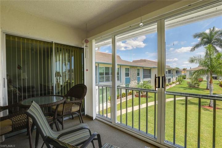 Lanai with sliders to primary bedroom, exterior side sliders to expand air conditioned space.