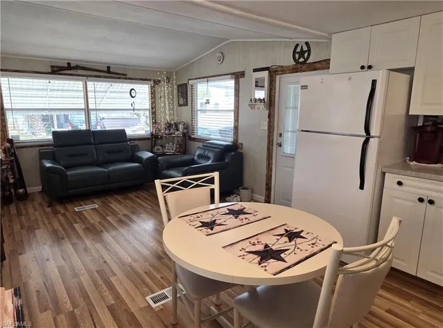 Kitchen and Living Room feature cathedral ceilings and lustrous wood laminate flooring.