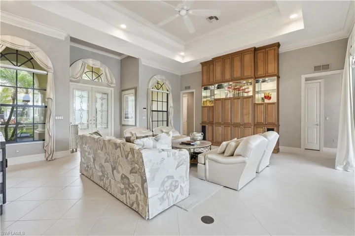 An elegant living room opens seamlessly to the kitchen and dining area.