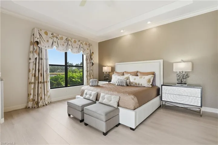 A spacious primary bedroom overlooking the pool.