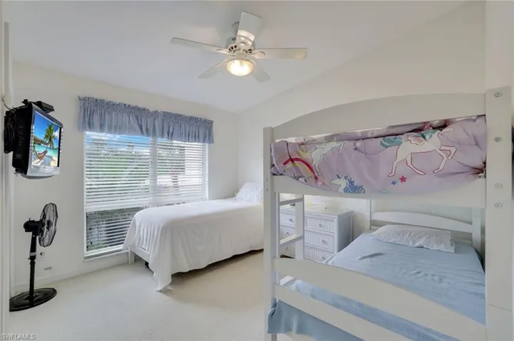 Generously sized 2nd Bedroom with ceiling fan and carpet floors