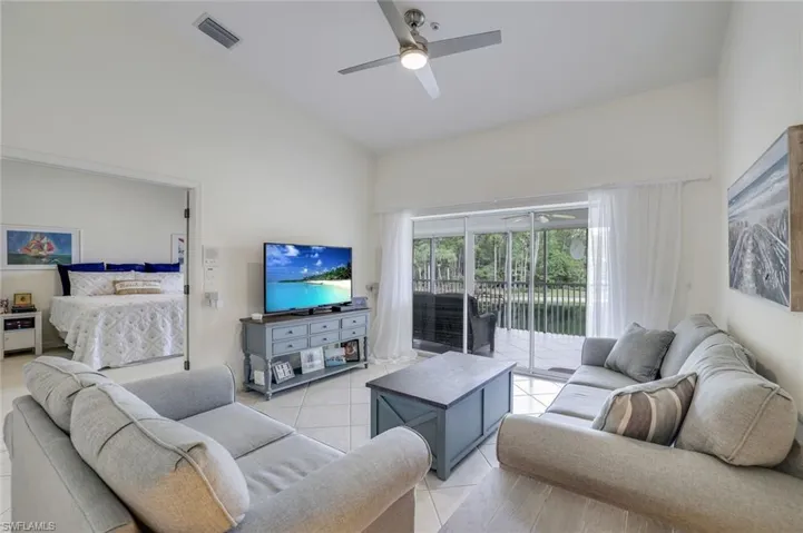 Tiled living room featuring Lanai Access & Beautiful View of the Pond