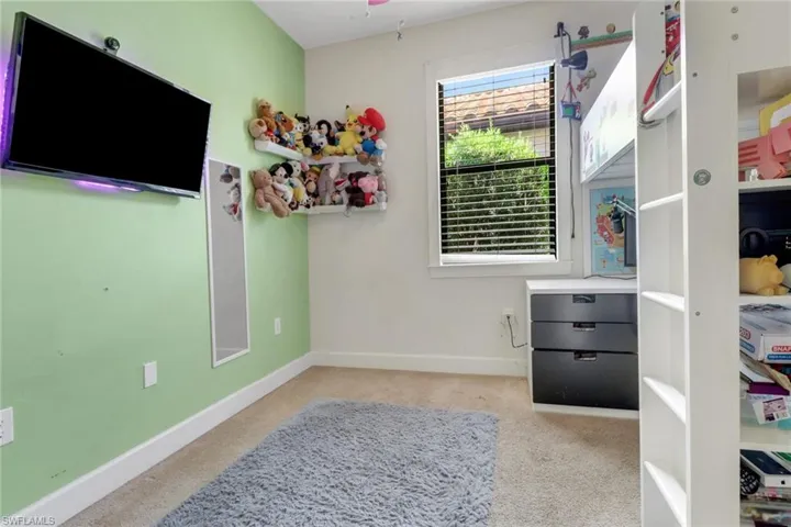 Bedroom with carpet flooring and baseboards
