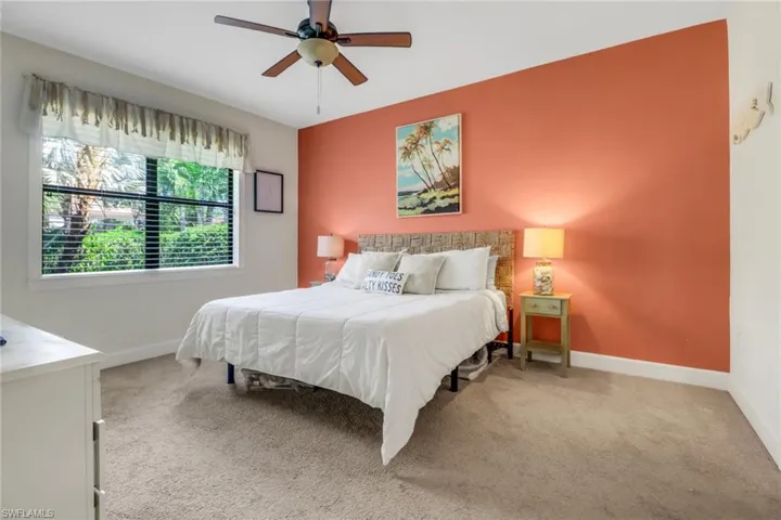 Bedroom featuring carpet floors, baseboards, and ceiling fan