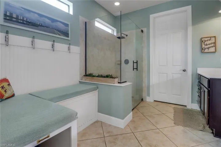 Full bathroom with tile patterned floors and a stall shower