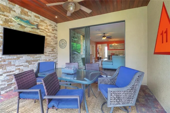 View of patio with a ceiling fan and outdoor dining space