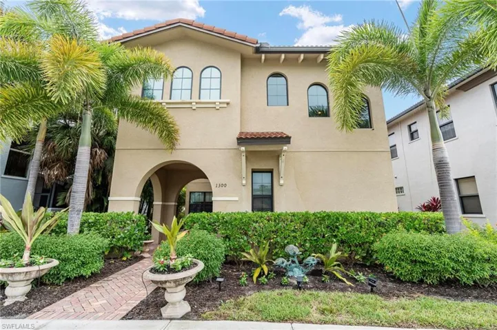 View of front facade featuring a tiled roof and stucco siding